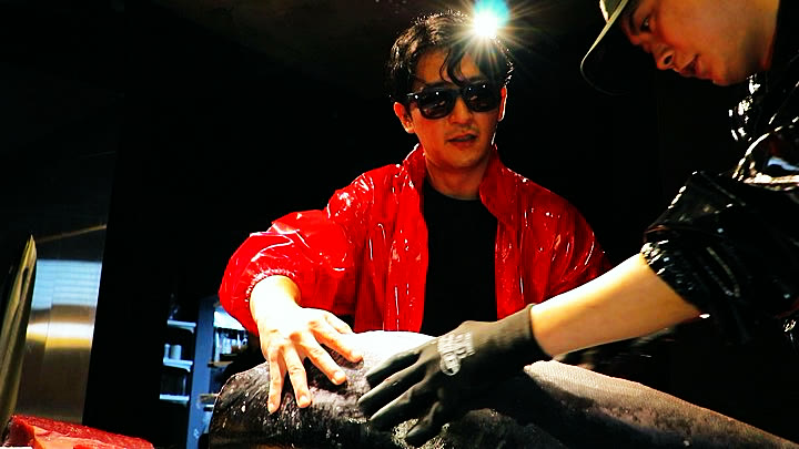 Two people working on the tuna