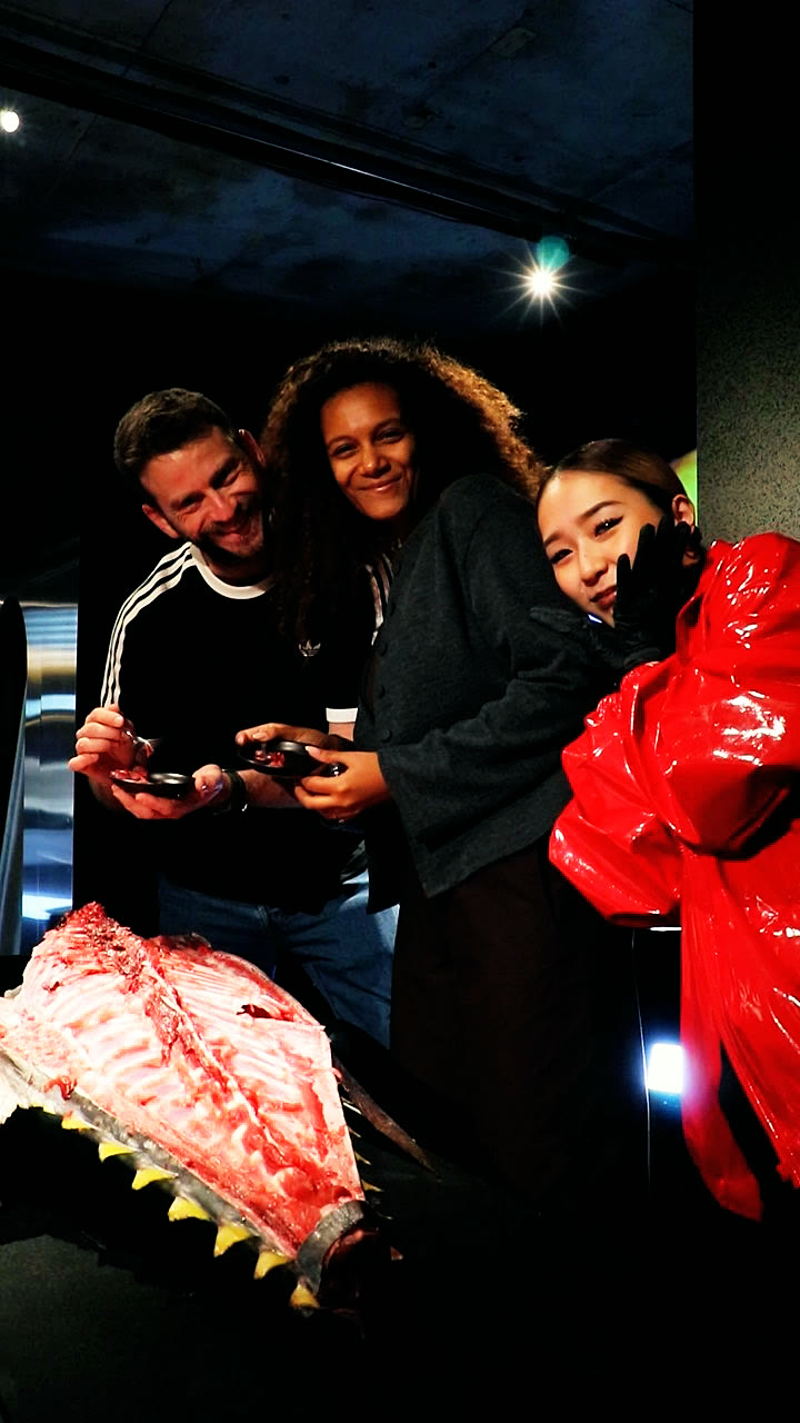 Two guests holding the nakaochi they scraped, with a member of the team